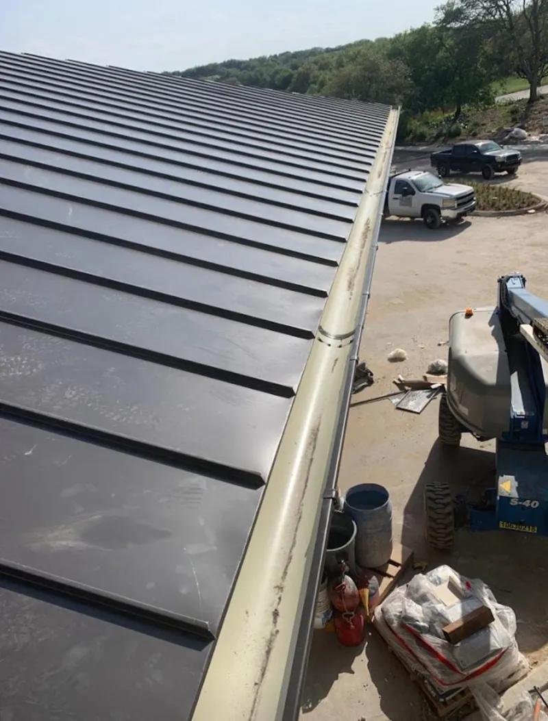 Standing seam panel and gutter detail on a metal roofing jobsite in Towson